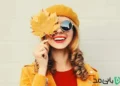 یک دختر با عینک آفتابی و برگ های پاییزی