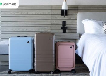 تصویری از 3 چمدون در رنگ‌های متفاوت که در اتاق هتل قرار دارند